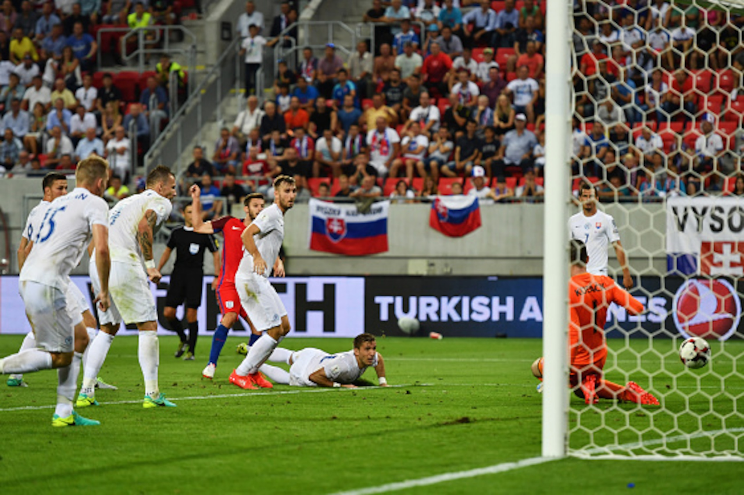 TRNAVA, SLOVAKIA - SEPTEMBER 04:  Adam Lallana of England (obscured) shoots past goalkeeper Matus Kozacik of Slovakia to score their first goal during the 2018 FIFA World Cup Group F qualifying match between Slovakia and England at City Arena on September