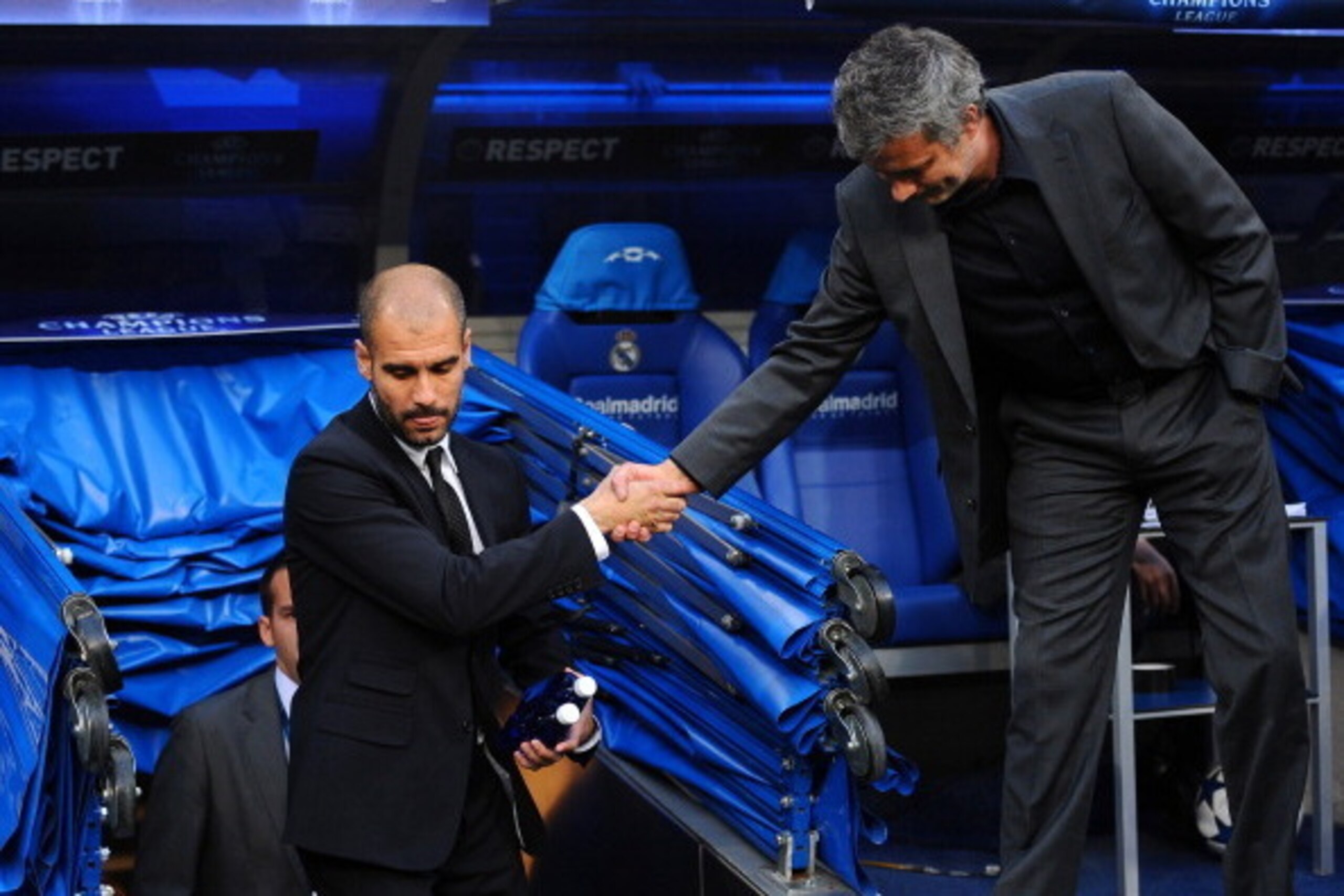 Barcelona's coach Josep Guardiola (L) and Real Madrid's Portuguese coach Jose Mourinho shake hands before the Champions League semi-final first leg football match between Real Madrid and Barcelona at the Santiago Bernabeu stadium in Madrid on April 27, 20