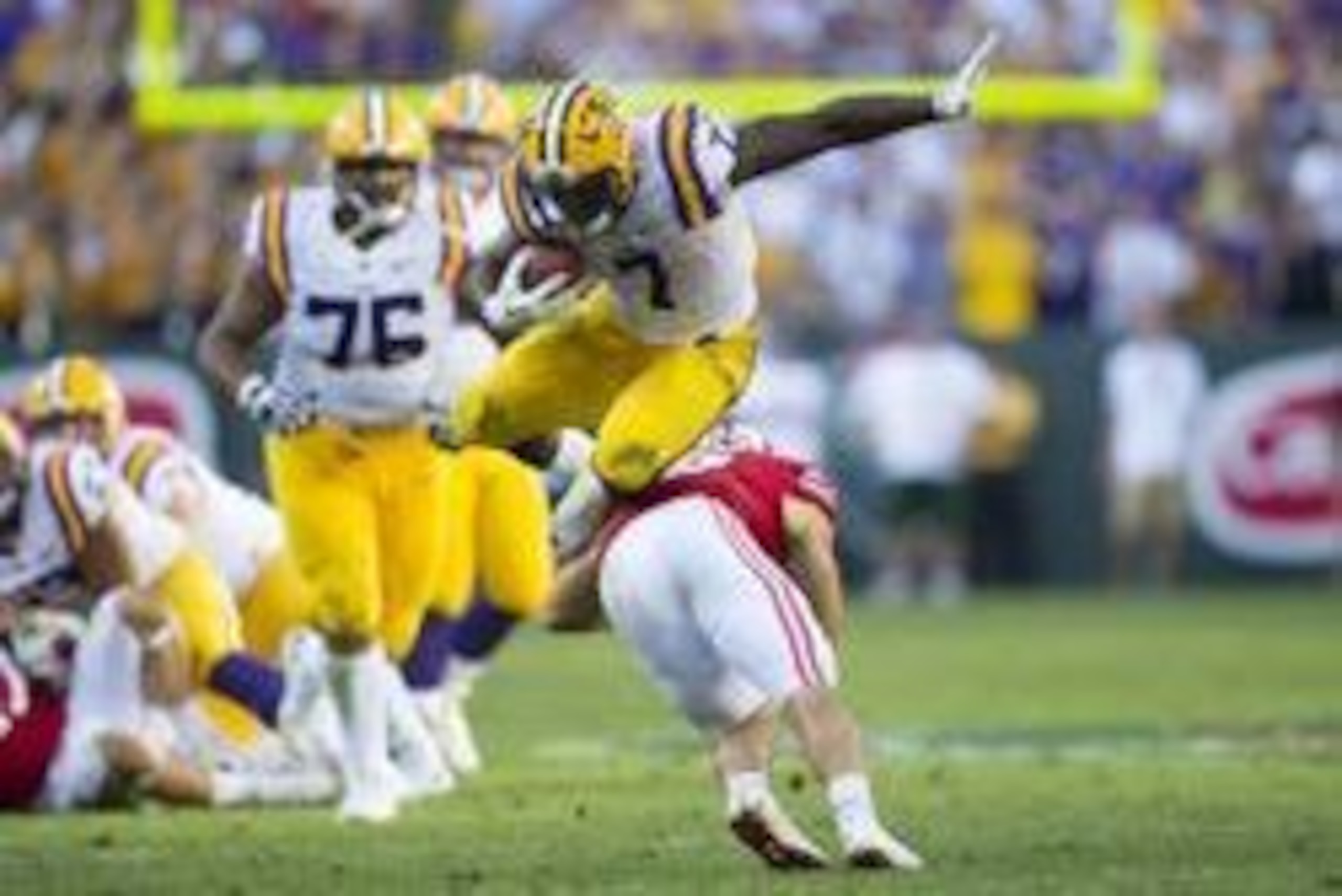 Sep 3, 2016; Green Bay, WI, USA;   LSU Tigers running back Leonard Fournette (7) leaps over Wisconsin Badgers safety Leo Musso (19) during the fourth quarter at Lambeau Field. Mandatory Credit: Jeff Hanisch-USA TODAY Sports