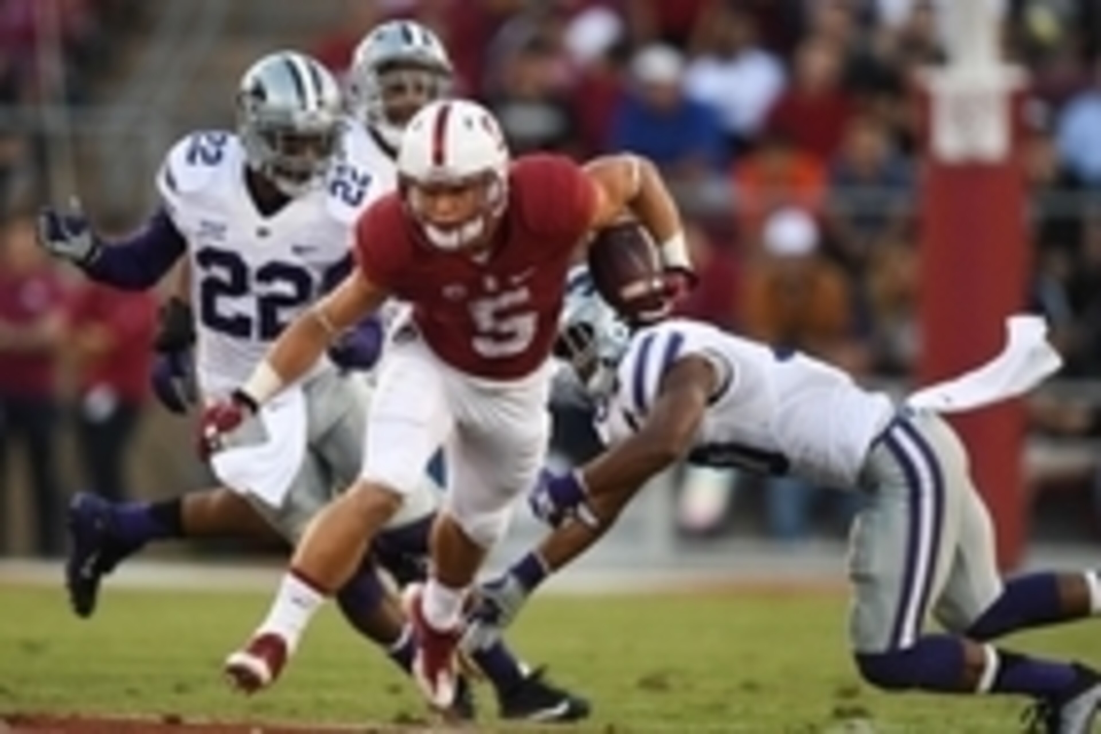 September 2, 2016; Stanford, CA, USA; Stanford Cardinal running back Christian McCaffrey (5) runs with the football past Kansas State Wildcats defensive back Dante Barnett (22) and defensive back Donnie Starks (10) during the second quarter at Stanford St