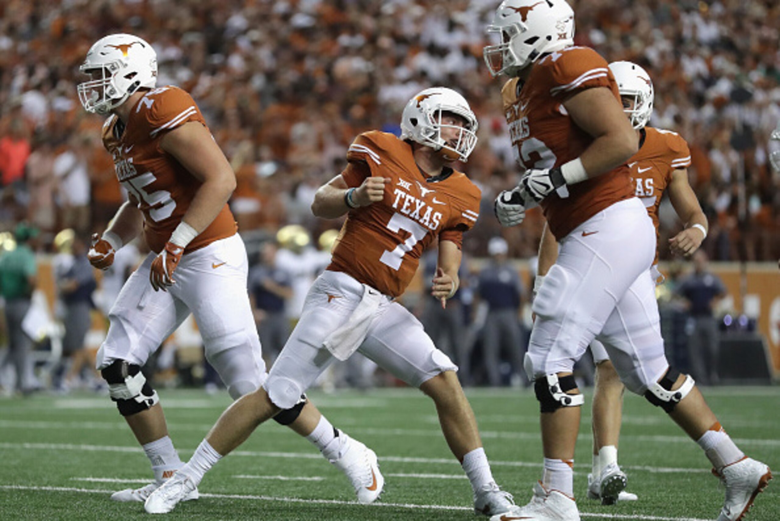AUSTIN, TX - SEPTEMBER 04: Shane Buechele #7 of the Texas Longhorns celebrates with teammates after a second quarter touchdown against the Notre Dame Fighting Irish at Darrell K. Royal-Texas Memorial Stadium on September 4, 2016 in Austin, Texas. (Photo AUSTIN, TX - SEPTEMBER 04: Shane Buechele #7 of the Texas Longhorns celebrates with teammates after a second quarter touchdown against the Notre Dame Fighting Irish at Darrell K. Royal-Texas Memorial Stadium on September 4, 2016 in Austin, Texas. (Photo