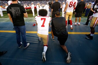 SAN DIEGO, CA - SEPTEMBER 1: Eric Reid #35 and Colin Kaepernick #7 of the San Francisco 49ers kneel on the sideline during the anthem, as free agent Nate Boyer stands, prior to the game against the San Diego Chargers at Qualcomm Stadium on September 1, 20