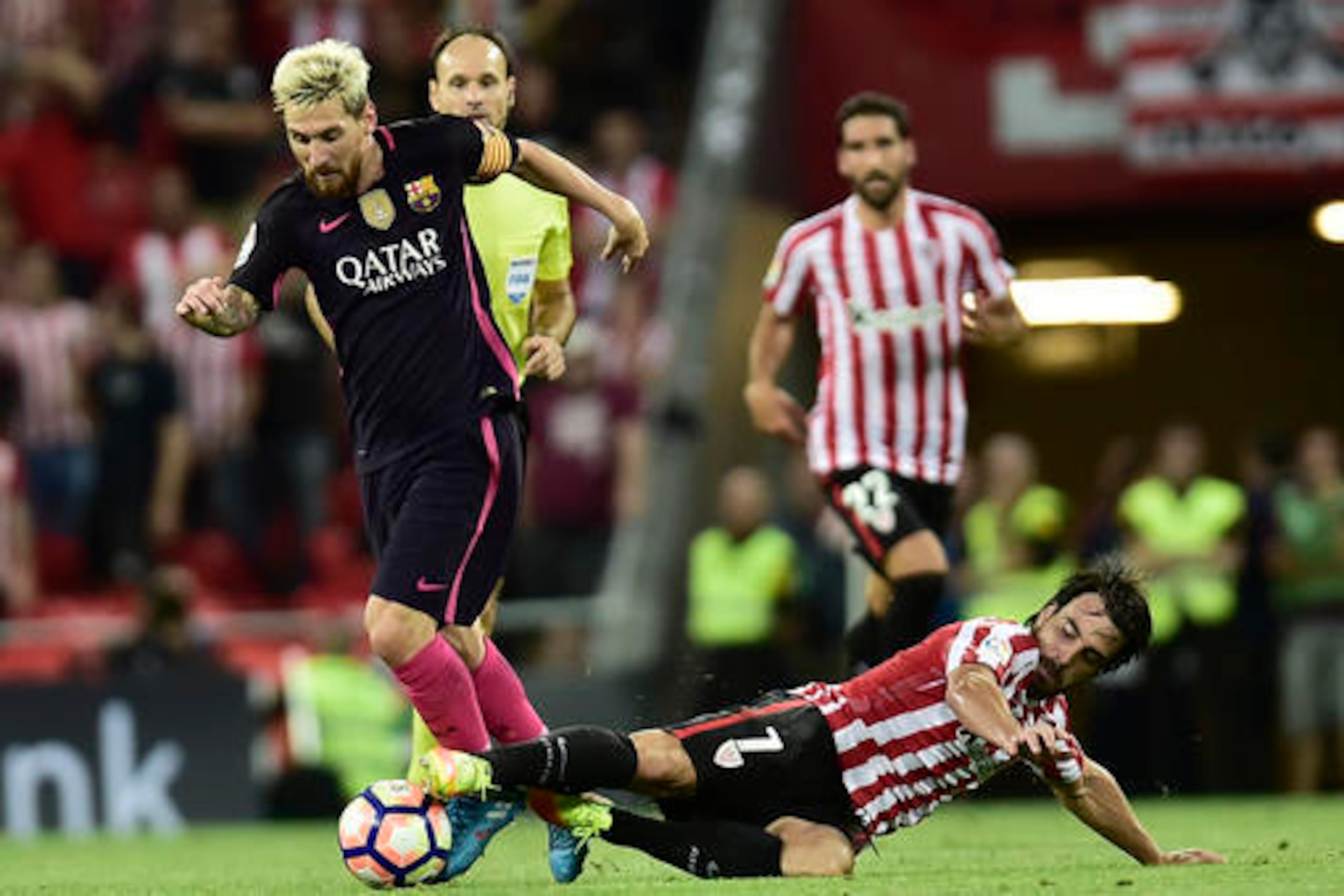 Messi skips away from a lunging Athletic Bilbao tackle.