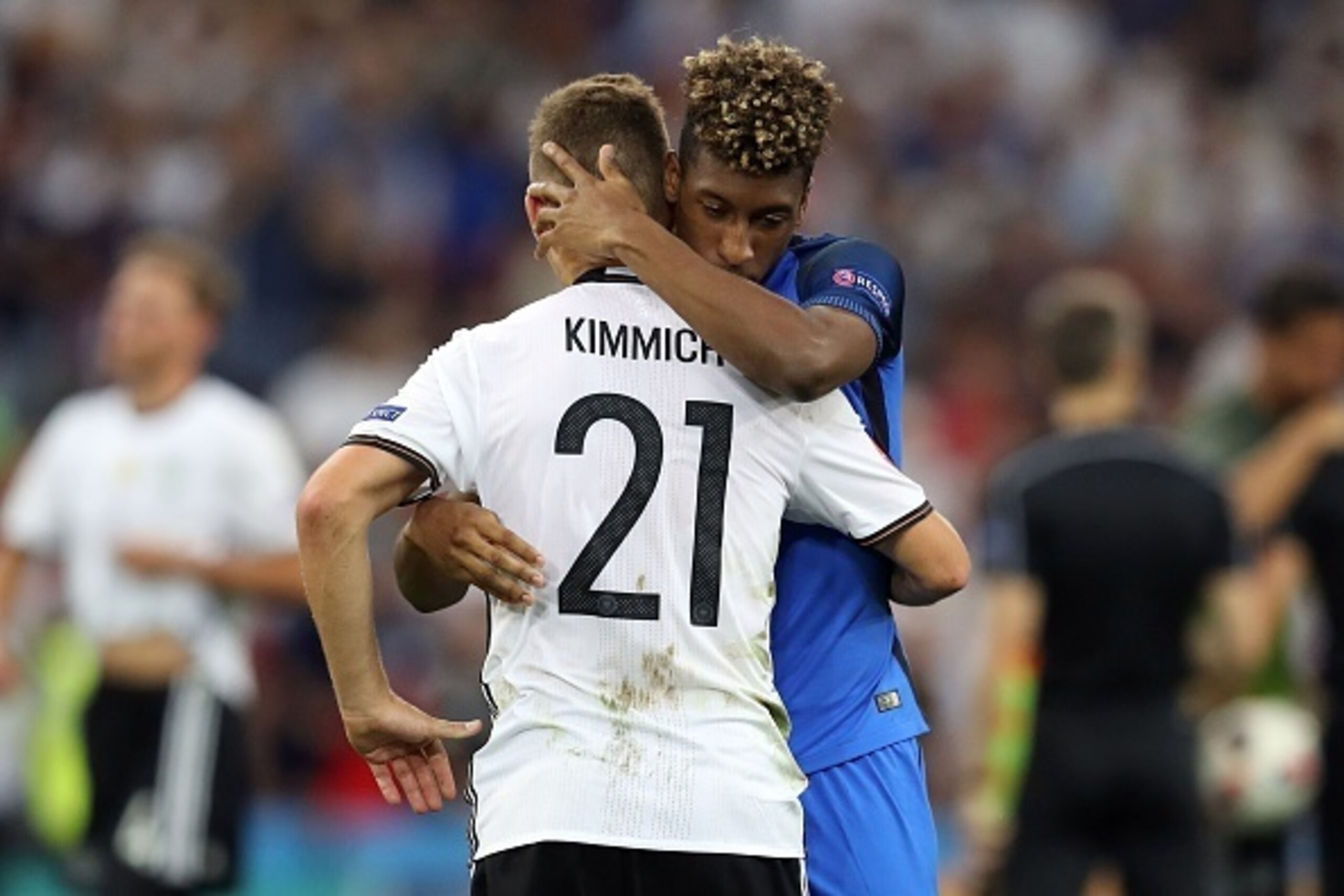 France's forward Kingsley Coman (R) hugs Germany's midfielder Joshua Kimmich (L) after the  Euro 2016 semi-final football match between Germany and France at the Stade Velodrome in Marseille on July 7, 2016.
 / AFP / Valery HACHE        (Photo credit shou