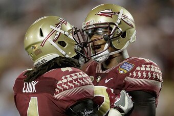 ORLANDO, FL - SEPTEMBER 05:  Teammates Dalvin Cook #4 and Deondre Francois #12 of the Florida State Seminoles celebrate after a touchdown during the Camping World Kickoff at Camping World Stadium on September 5, 2016 in Orlando, Florida.  (Photo by Street