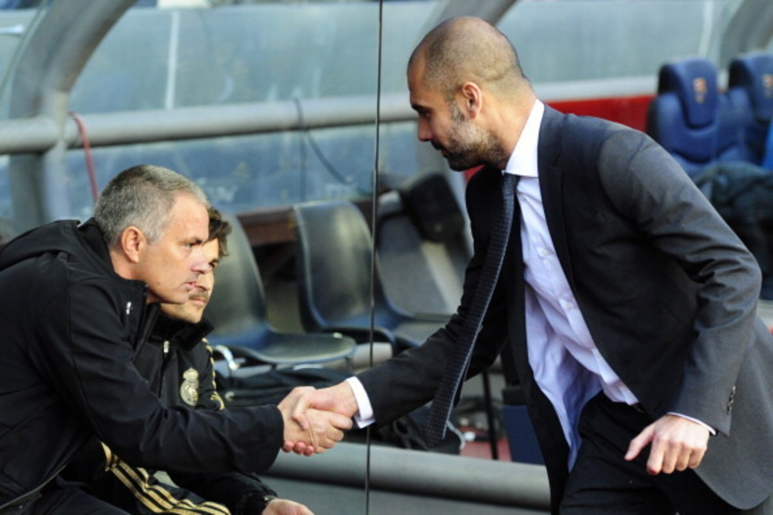 Real Madrid's Portuguese coach Jose Mourinho (L) shakes hands with Barcelona's coach Josep Guardiola (R) during the Spanish League 'El clasico' football match Barcelona vs Real Madrid at the Camp Nou stadium in Barcelona on April 21, 2012.  AFP PHOTO/JAVI