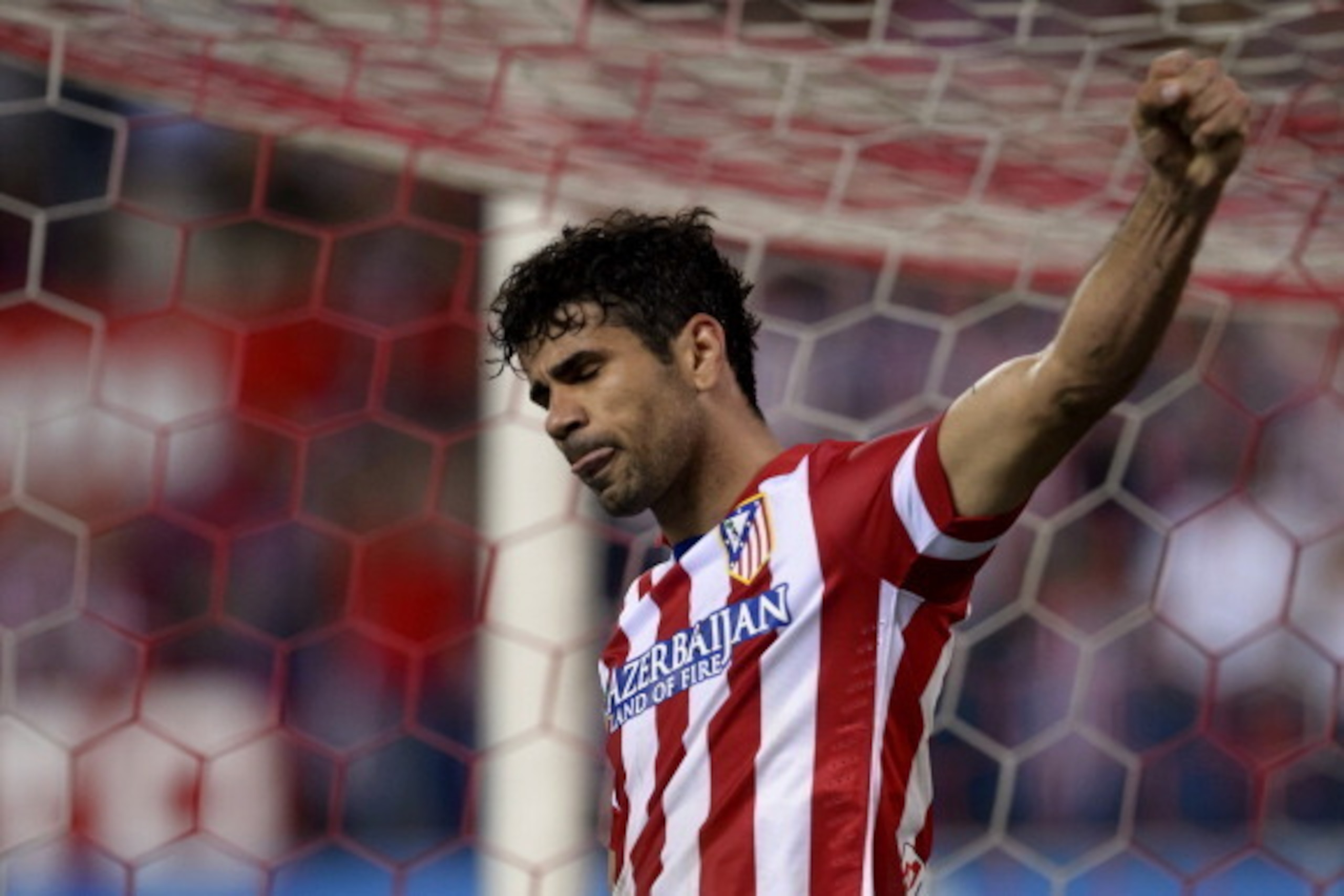 Atletico Madrid's Brazilian-born forward Diego da Silva Costa celebrates after scoring during the Spanish league football match Club Atletico de Madrid vs Elche CF at the Vicente Calderon stadium in Madrid on April 18, 2014. Atletico won 2-0.    AFP PHOTO
