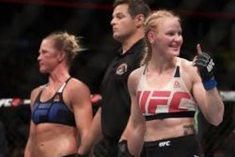 July 23, 2016; Chicago, IL, USA;  Valentina Shevchenko (blue gloves) celebrates after defeating Holly Holm in their women's bantamweight bout during UFC Fight Night at United Center. Mandatory Credit: Kamil Krzaczynski-USA TODAY Sports