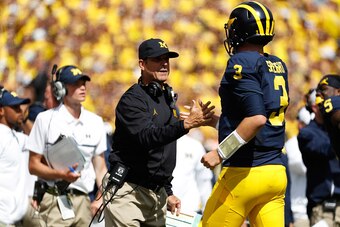 ANN ARBOR, MI - SEPTEMBER 03: Head coach Jim Harbaugh of the Michigan Wolverines congratulates Wilton Speight #3 on a first quarter touchdown pass on September 3, 2016 at Michigan Stadium in Ann Arbor, Michigan. (Photo by Gregory Shamus/Getty Images)