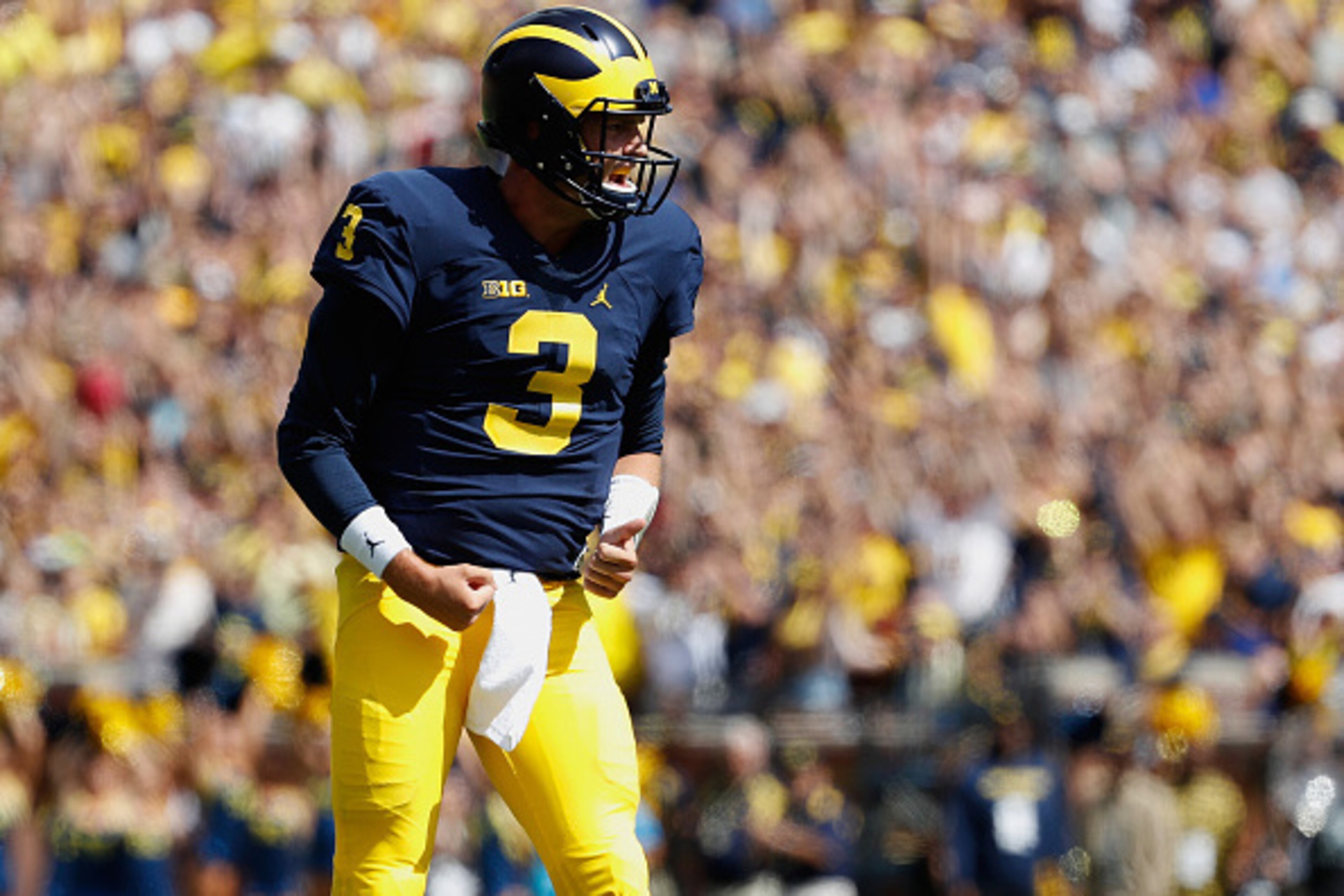ANN ARBOR, MI - SEPTEMBER 03: Wilton Speight #3 of the Michigan Wolverines celebrates a first quarter touchdown pass to Grant Perry #9 while playing the Hawaii Warriors on September 3, 2016 at Michigan Stadium in Ann Arbor, Michigan. (Photo by Gregory Sha