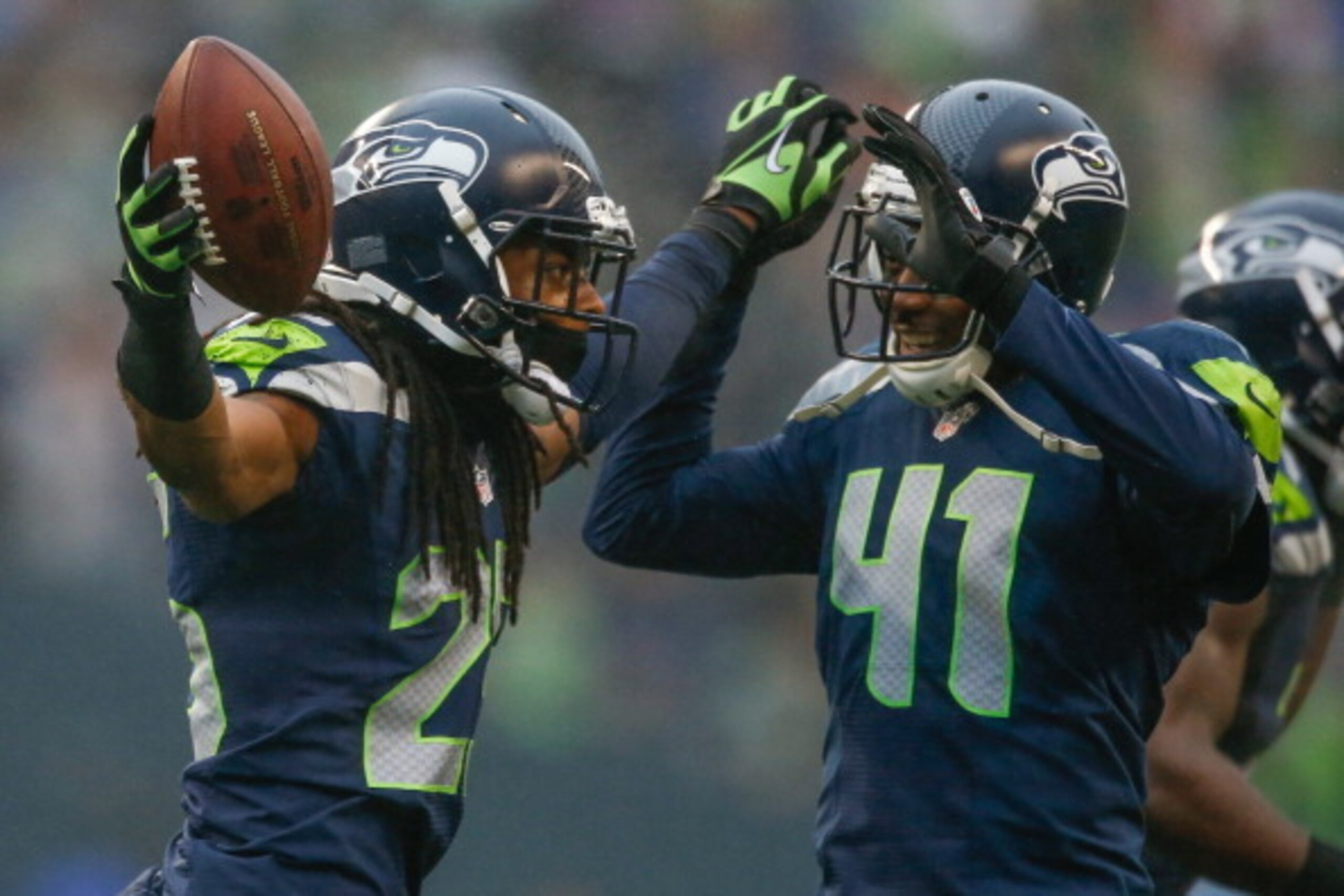 SEATTLE, WA - DECEMBER 22:  Cornerback Richard Sherman #25 of the Seattle Seahawks celebrates with defensive back Byron Maxwell #41 after making an interception against the Arizona Cardinals at CenturyLink Field on December 22, 2013 in Seattle, Washington