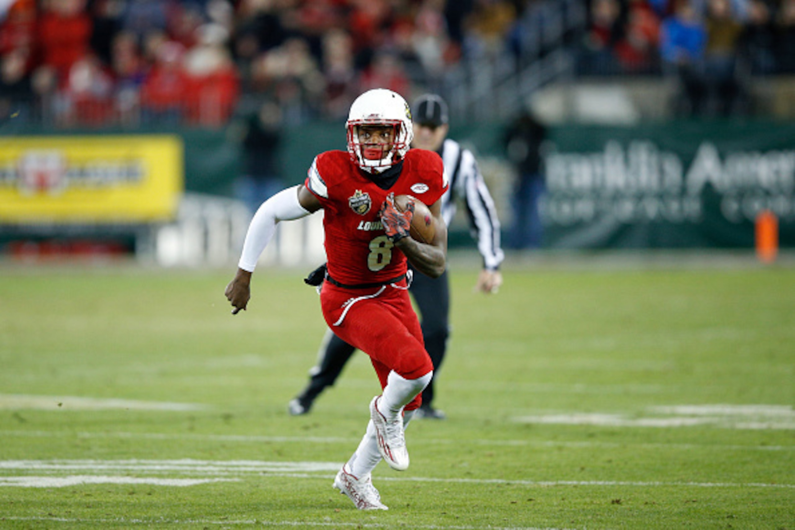 NASHVILLE, TN - DECEMBER 30: Lamar Jackson #8 of the Louisville Cardinals runs the ball against the Texas A&M Aggies during the Franklin American Mortgage Music City Bowl at Nissan Stadium on December 30, 2015 in Nashville, Tennessee. Louisville defeated 