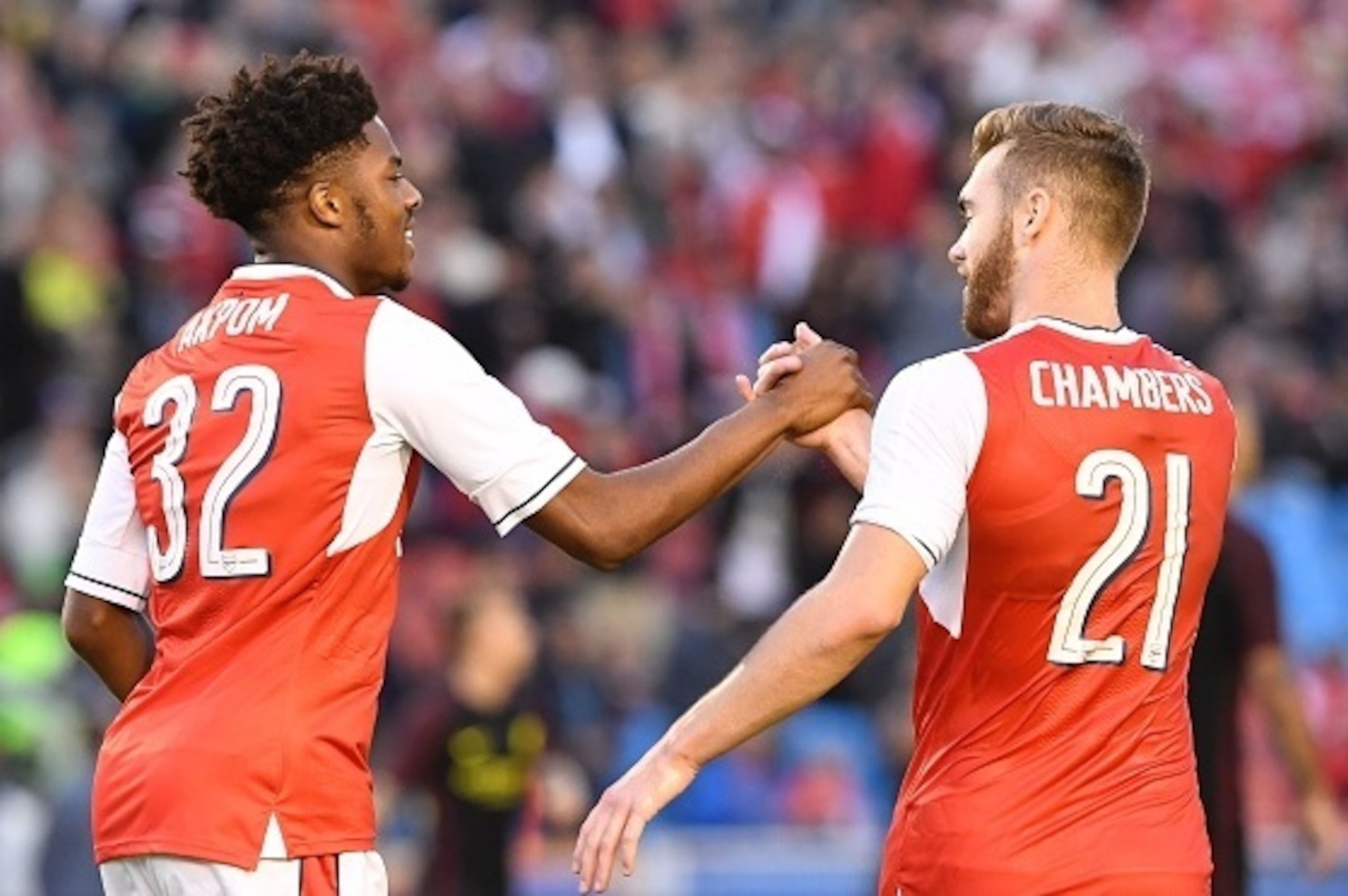 Arsenal's English forward Chuba Akpom celebrates with his teammate English defender Calum Chambers (R) after scoring during the friendly football match between Arsenal and Manchester City at the Ullevi stadium in Gothenburg on August 7, 2016. / AFP / JONA