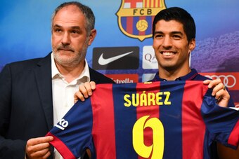 BARCELONA, SPAIN - AUGUST 19:  (L-R) FC Barcelona Sport Director Andoni Zubizarreta and Luis Suarez of FC Barcelona pose for the media during a press conference as part of his presentation as new FC Barcelona player at Camp Nou on August 19, 2014 in Barce