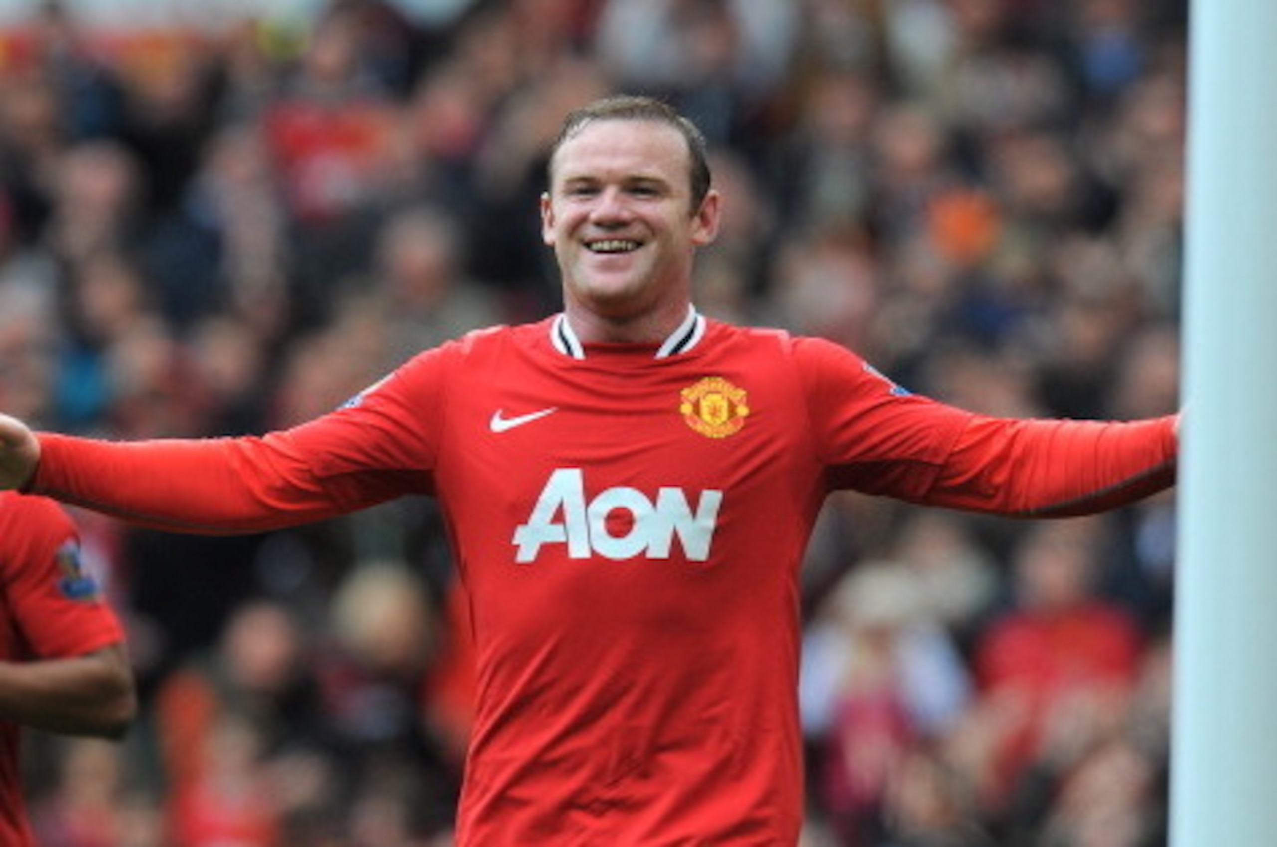 Manchester United's English forward Wayne Rooney celebrates after scoring the fourth goal during the English Premier League football match between Manchester United and Everton at Old Trafford in Manchester, north-west England on April 22 2012. AFP PHOTO/