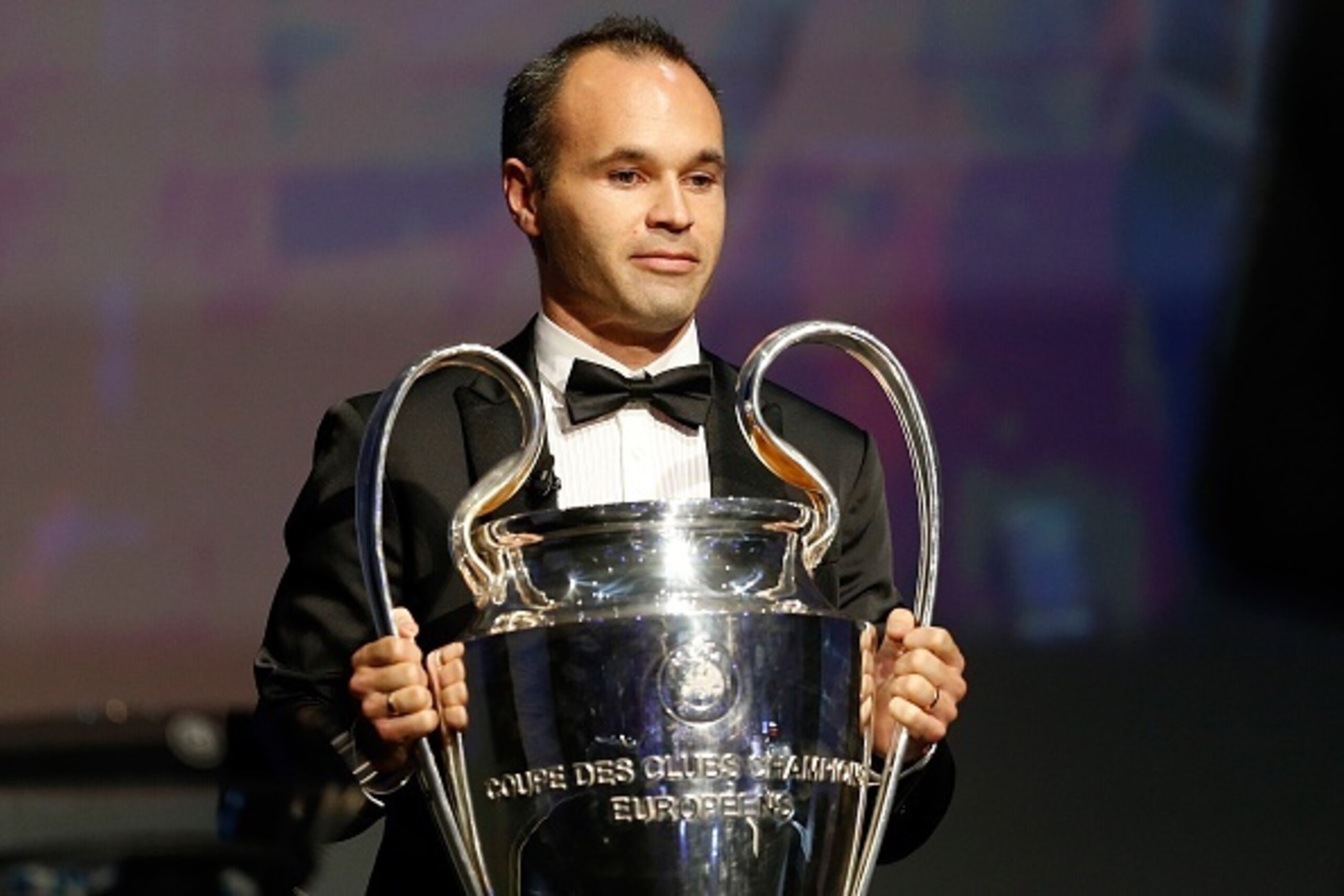 FC Barcelona's captain Andres Iniesta holds the Champions League trophy at the start of the UEFA Champions League Group stage draw ceremony, on August 27, 2015 in Monaco. AFP PHOTO / VALERY HACHE        (Photo credit should read VALERY HACHE/AFP/Getty Ima