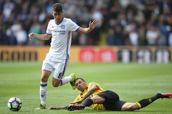 WATFORD, ENGLAND - AUGUST 20: Oscar of Chelsea is tackled by Craig Cathcart of Watford during the Premier League match between Watford and Chelsea at Vicarage Road on August 20, 2016 in Watford, England.  (Photo by Steve Bardens/Getty Images)
