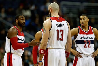 WASHINGTON, DC - JANUARY 08: John Wall #2 of the Washington Wizards talks with Marcin Gortat #13 and Otto Porter Jr. #22 during the first half against the Toronto Raptors at Verizon Center on January 8, 2016 in Washington, DC. NOTE TO USER: User expressly