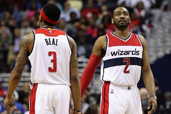 WASHINGTON, DC - MARCH 23:  Bradley Beal #3 and John Wall #2 of the Washington Wizards talk in the first half against the Atlanta Hawks at Verizon Center on March 23, 2016 in Washington, DC. NOTE TO USER: User expressly acknowledges and agrees that, by do