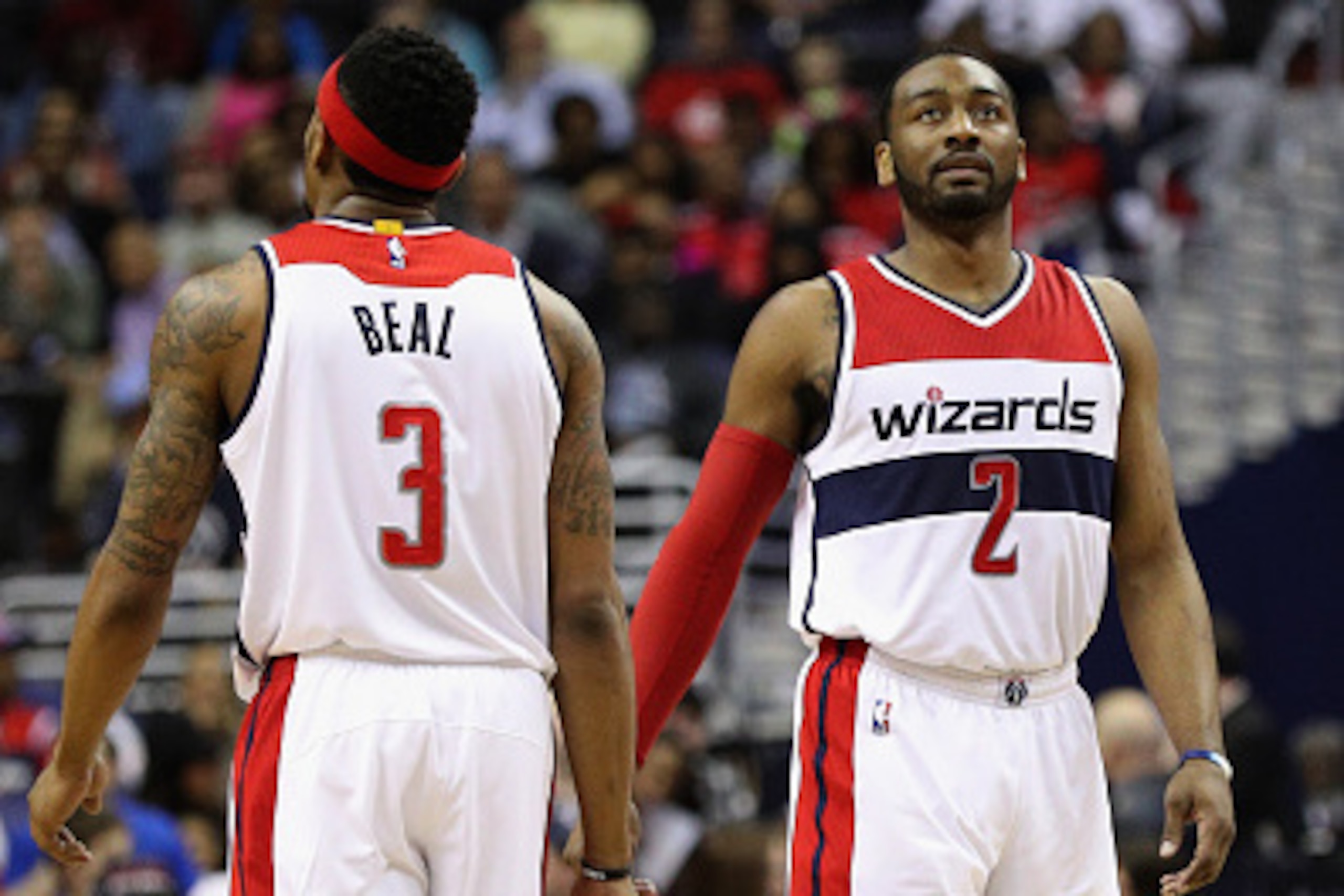 WASHINGTON, DC - MARCH 23:  Bradley Beal #3 and John Wall #2 of the Washington Wizards talk in the first half against the Atlanta Hawks at Verizon Center on March 23, 2016 in Washington, DC. NOTE TO USER: User expressly acknowledges and agrees that, by do
