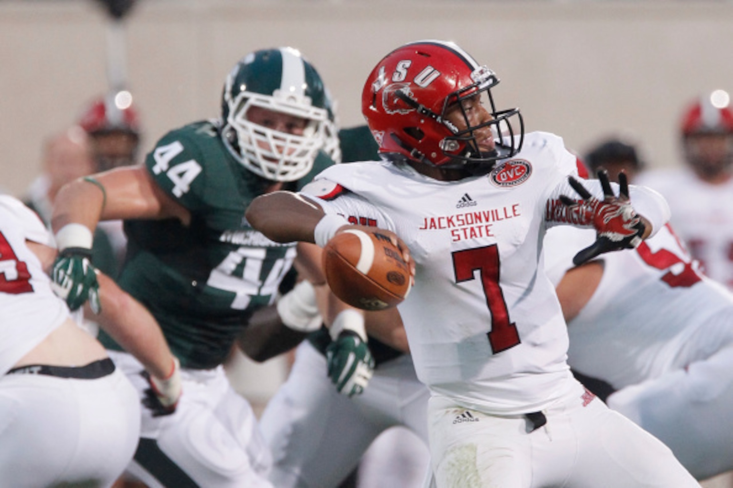 EAST LANSING, MI - AUGUST 29:  Marcus Rush #44 of the Michigan State Spartans closes in on Quarterback Eli Jenkins #7 of the Jacksonville State Gamecocks during the first half at Spartan Stadium on August 29, 2014 in East Lansing, Michigan. (Photo by Duan
