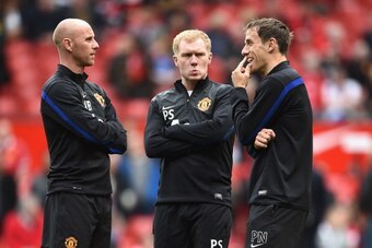 MANCHESTER, ENGLAND - APRIL 26:  l-r Nicky Butt, Paul Scholes and Phil Neville of Manchester United watch over the players during warm up during the Barclays Premier League match between Manchester United and Norwich City at Old Trafford on April 26, 2014
