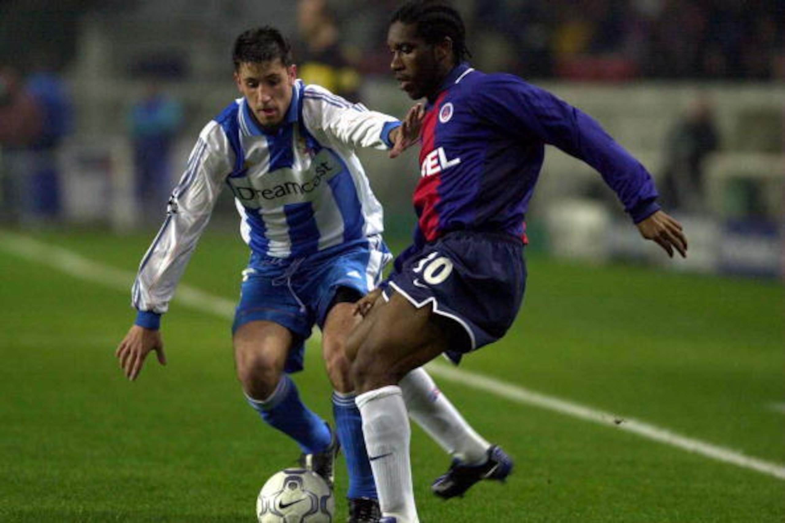 21 Nov 2000:  Augustine Okocha of Paris is watched by a Deportivo La Coruna defender during the Champions League Group B match between Paris St Germain v Deportivo La Coruna at Parc des Princes, Paris, France. Mandatory Credit: Stu Forster/ALLSPORT