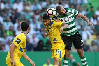 LISBON, PORTUGAL - AUGUST 28: Sporting CP's forward Islam Slimani from Algeria with FC Porto's defender from Brazil Alex Telles in action during the Primeira Liga match between Sporting CP and FC Porto at Estadio Jose Alvalade on August 28, 2016 in Lisbon