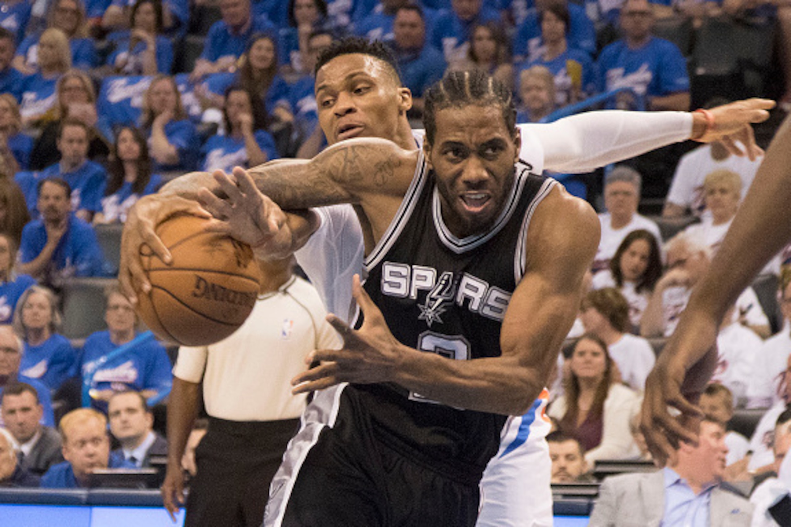 OKLAHOMA CITY, OK - MAY 6: Kawhi Leonard #2 of the San Antonio Spurs drives around Russell Westbrook #0 of the Oklahoma City Thunder during the first half of Game Three of the Western Conference Semifinals during the 2016 NBA Playoffs at the Chesapeake En