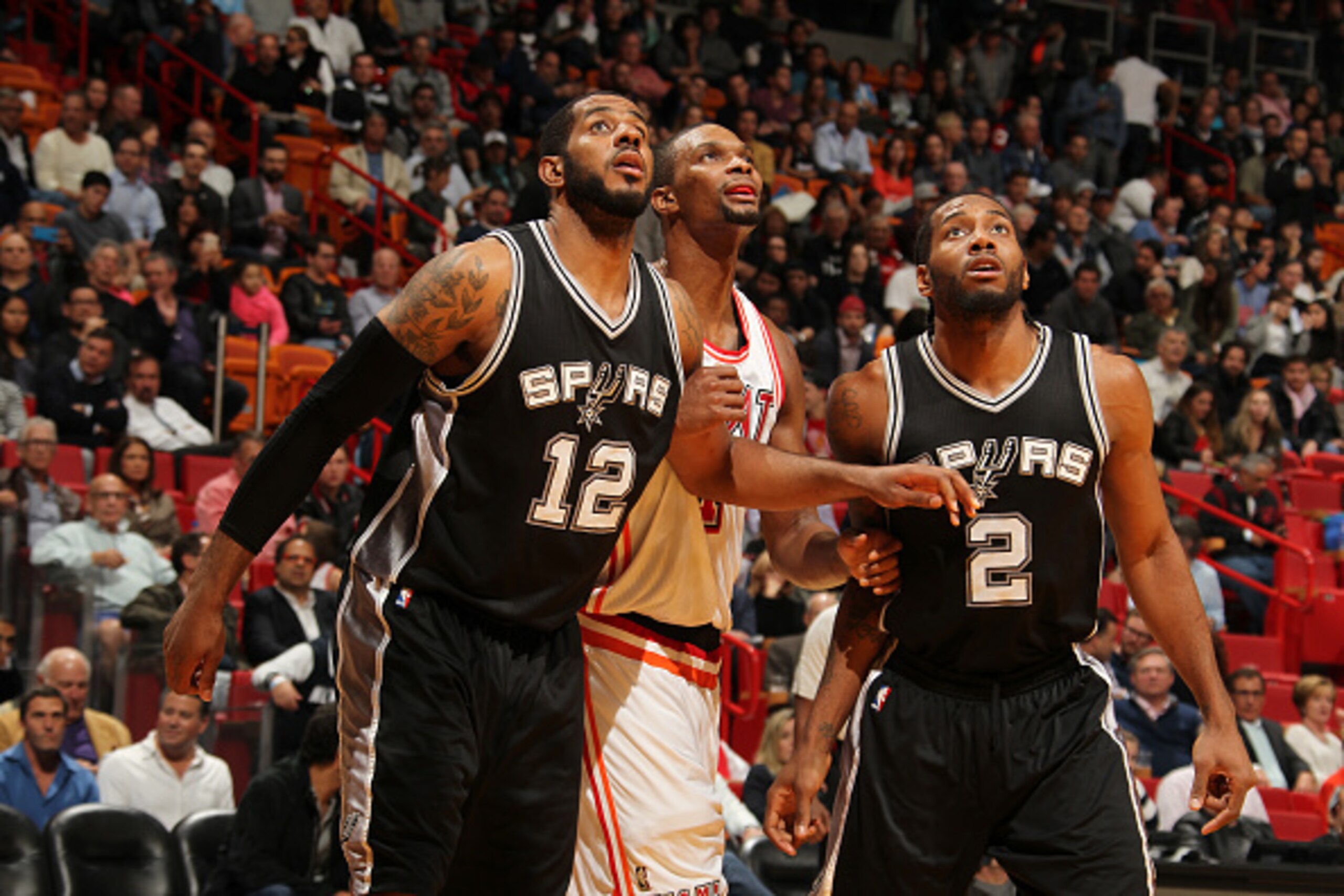 MIAMI, FL - FEBRUARY 9:  LaMarcus Aldridge #12 of the San Antonio Spurs and Kawhi Leonard #2 of the San Antonio Spurs boxes out against Chris Bosh #1 of the Miami Heat during the game on February 9, 2016 at American Airlines Arena in Miami, Florida. NOTE 