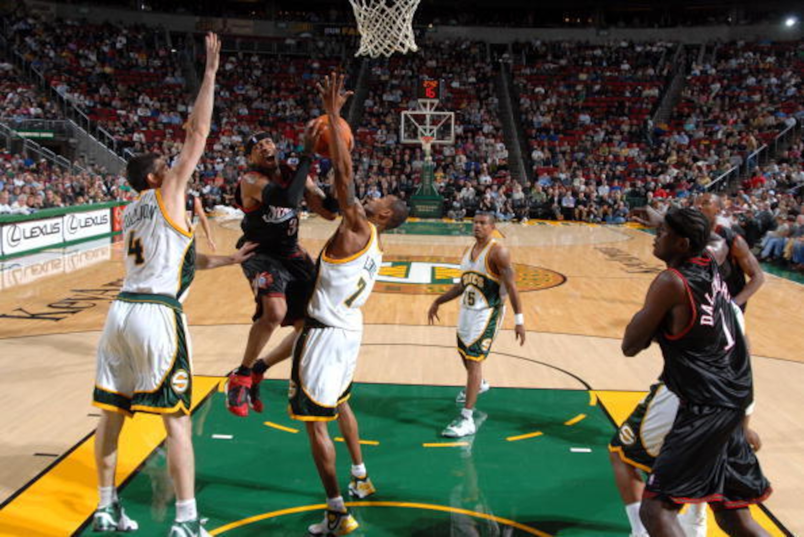 SEATTLE - NOVEMBER 15:  Allen Iverson #3 of the Philadelphia 76ers goes to the basket against the defense of Nick Collison #4 and Rashard Lewis #7 of the Seattle SuperSonics on November 15, 2006 at the Key Arena in Seattle, Washington.  NOTE TO USER: User