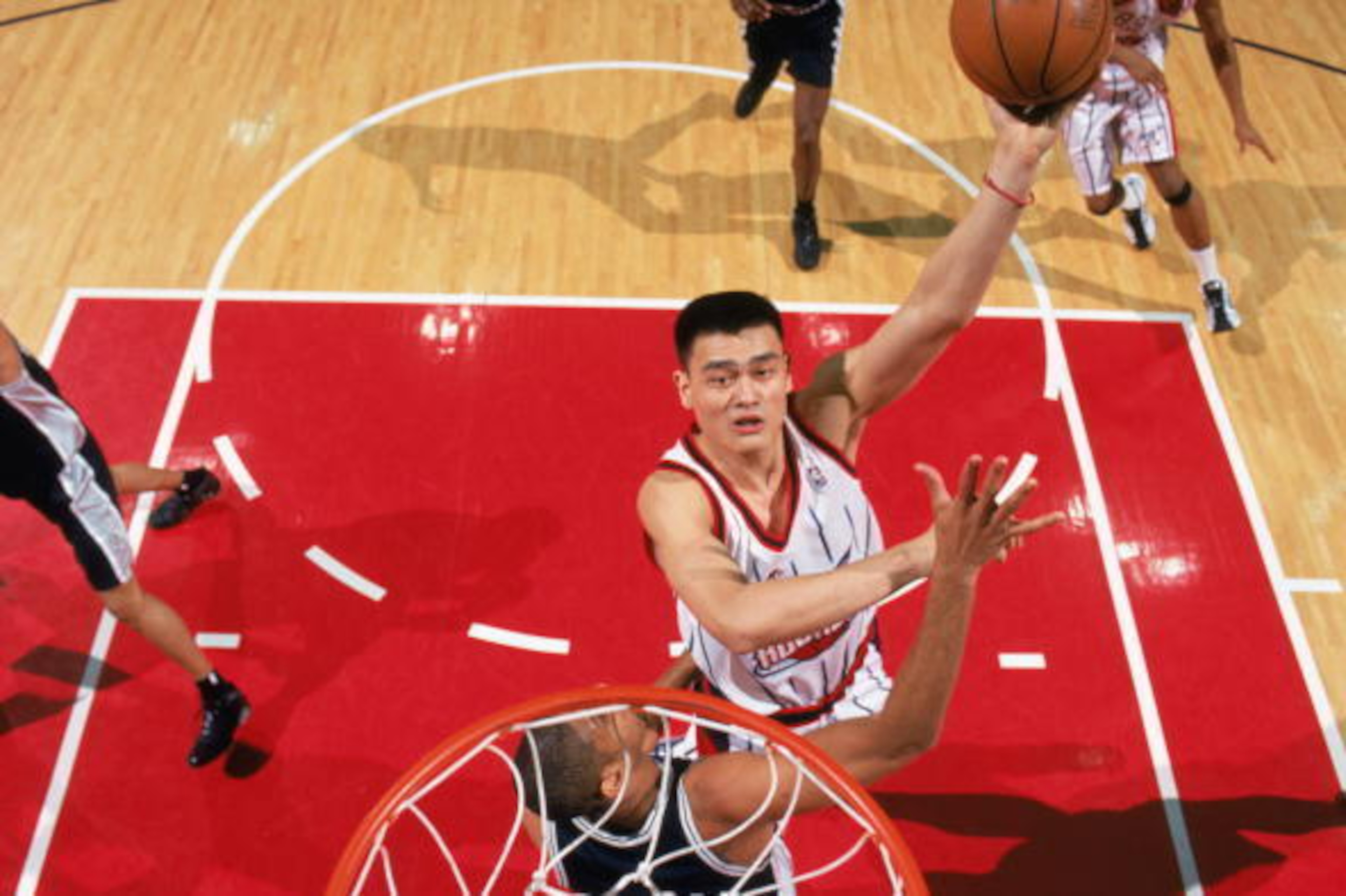 HOUSTON - MARCH 2:  Yao Ming #11 of the Houston Rockets takes the ball up against Tim Duncan #21 of the San Antonio Spurs during the game at Compaq Center on March 2, 2003 in Houston, Texas. The Spurs defeated the Rockets 97-88.  NOTE TO USER: User expres