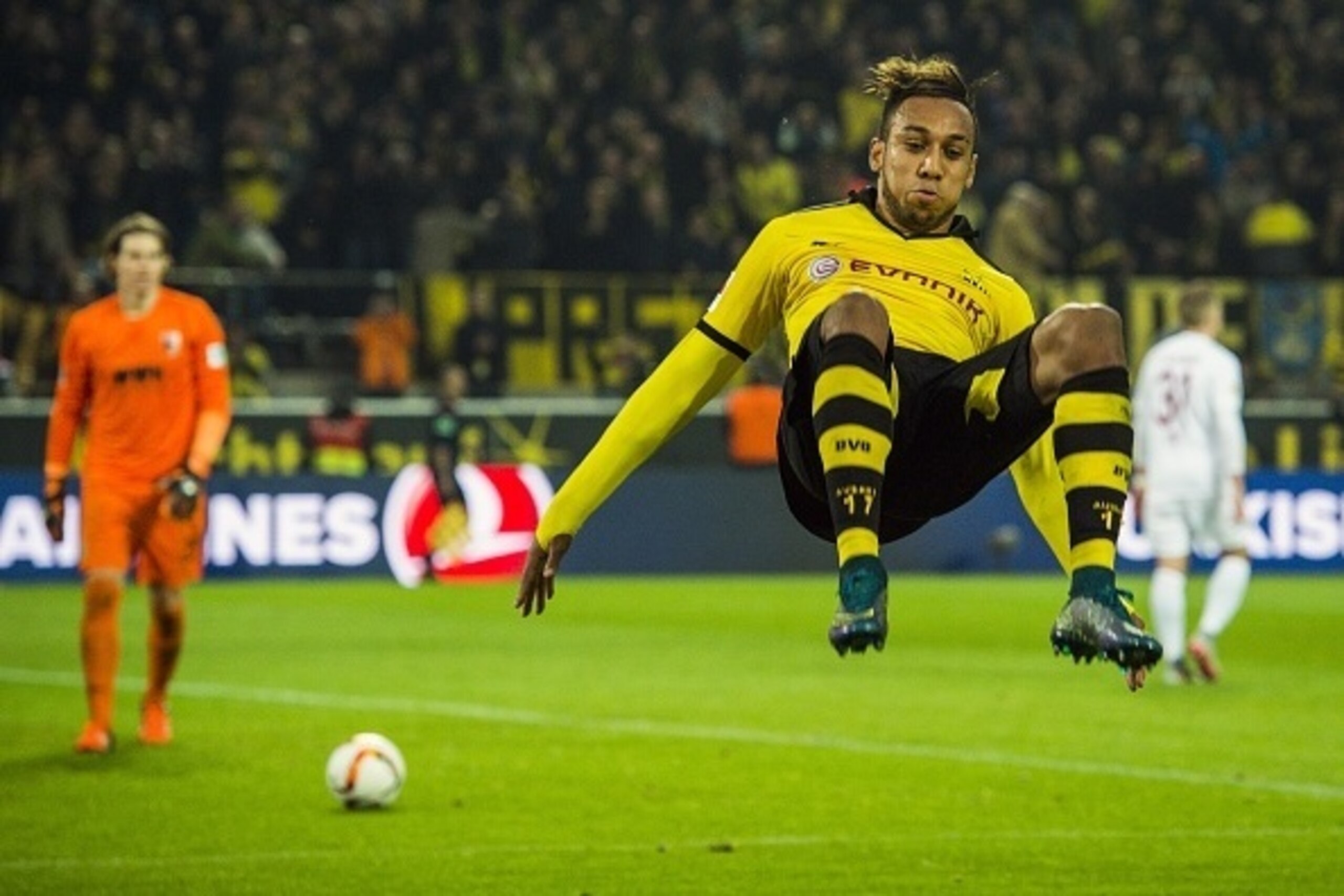 Dortmund's Gabonese midfielder Pierre-Emerick Aubameyang somersaults as he celebrates scoring his side's 5th goal to complete his hat-trick during the German first division football Bundesliga match between Borussia Dortmund and FC Augsburg on October 25,