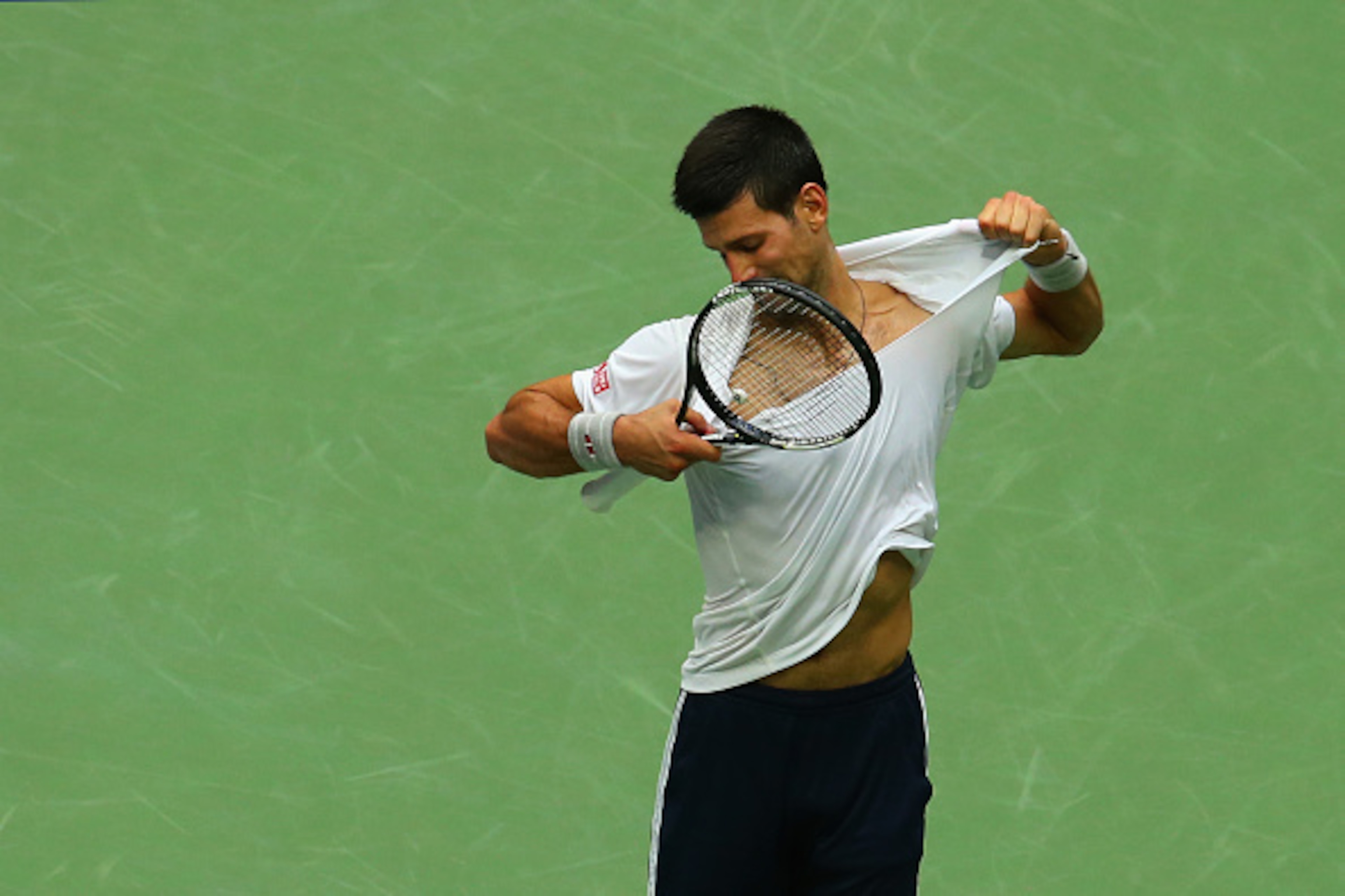 NEW YORK, NY - SEPTEMBER 09: Novak Djokovic of Serbia reacts by ripping off his shirt while playing against Gael Monfils of France during their Men's Singles Semifinal Match on Day Twelve of the 2016 US Open at the USTA Billie Jean King National Tennis C NEW YORK, NY - SEPTEMBER 09: Novak Djokovic of Serbia reacts by ripping off his shirt while playing against Gael Monfils of France during their Men's Singles Semifinal Match on Day Twelve of the 2016 US Open at the USTA Billie Jean King National Tennis C