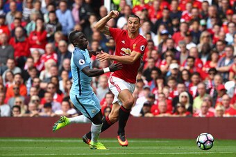 MANCHESTER, ENGLAND - SEPTEMBER 10: Zlatan Ibrahimovic of Manchester United (R) and Bacary Sagna of Manchester City (L) battle for possession during the Premier League match between Manchester United and Manchester City at Old Trafford on September 10, 20