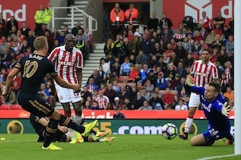 Tottenham Hotspur's English striker Harry Kane (2L) scores his team's fourth goal  during the English Premier League football match between Stoke City and Tottenham Hotspur at the Bet365 Stadium in Stoke-on-Trent, central England on September 10, 2016. / 