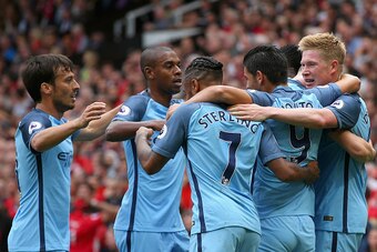 MANCHESTER, ENGLAND - SEPTEMBER 10: Kevin De Bruyne of Manchester City (R) celebrates scoring his sides first goal with his team mates during the Premier League match between Manchester United and Manchester City at Old Trafford on September 10, 2016 in M