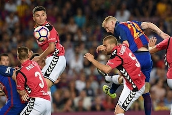 Barcelona's French defender Jeremy Mathieu (R) heads the ball to score a goal beside Deportivo Alaves' defender Laguardia (2nd R) during the Spanish league football match FC Barcelona vs Deportivo Alaves at the Camp Nou stadium in Barcelona on September 1