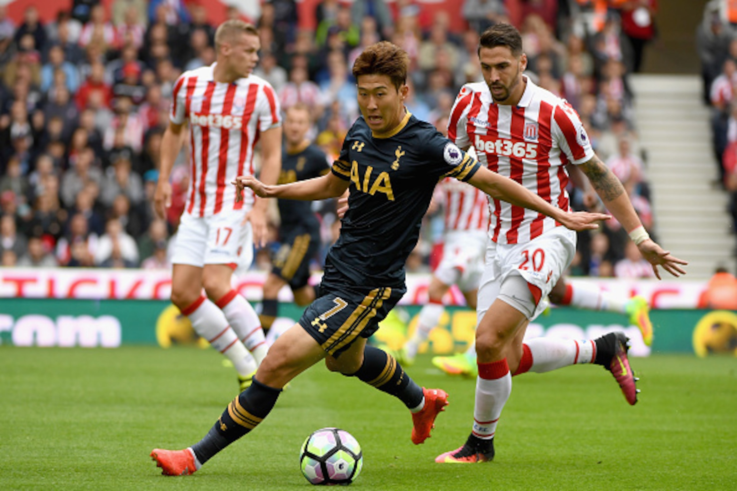 STOKE ON TRENT, ENGLAND - SEPTEMBER 10: Heung-Min Son of Tottenham Hotspur on the ball while under pressure Geoff Cameron of Stoke City during the Premier League match between Stoke City and Tottenham Hotspur at Britannia Stadium on September 10, 2016 in 