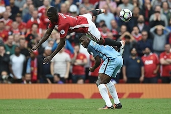 Manchester United's Ivorian defender Eric Bailly (L) vies with Manchester City's Nigerian striker Kelechi Iheanacho during the English Premier League football match between Manchester United and Manchester City at Old Trafford in Manchester, north west En