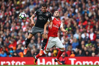 LONDON, ENGLAND - SEPTEMBER 10:  Cedric Soares of Southampton (L) and Lucas Perez of Arsenal (R) battle for possession during the Premier League match between Arsenal and Southampton at Emirates Stadium on September 10, 2016 in London, England.  (Photo by