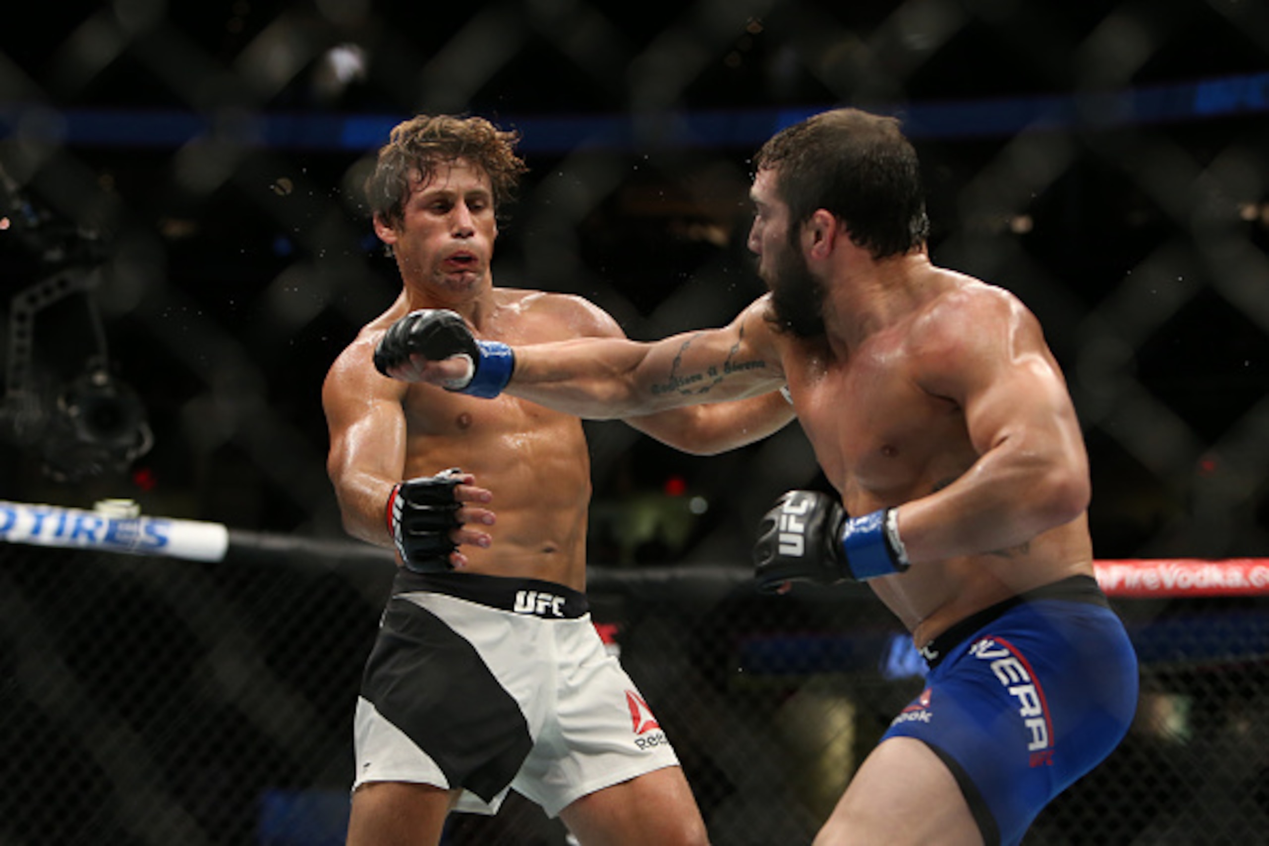 CLEVELAND, OH - SEPTEMBER 10:  Jimmie Rivera punches Urijah Faber during the UFC 203 event at Quicken Loans Arena on September 10, 2016 in Cleveland, Ohio. (Photo by Rey Del Rio/Getty Images)
