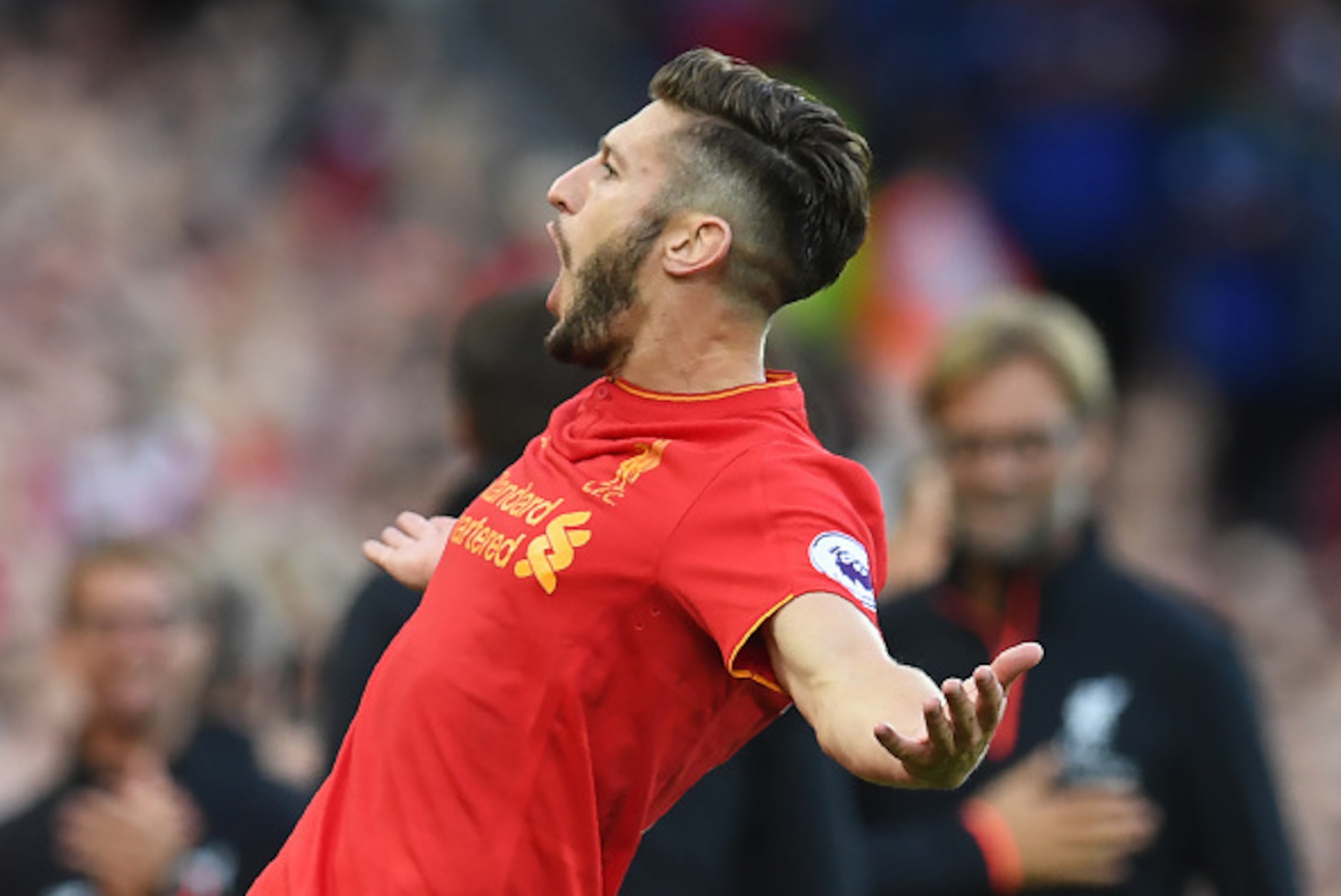 Liverpool's English midfielder Adam Lallana celebrates after scoring their third goal during the English Premier League football match between Liverpool and Leicester City at Anfield in Liverpool, north west England on September 10, 2016. / AFP / Paul ELL
