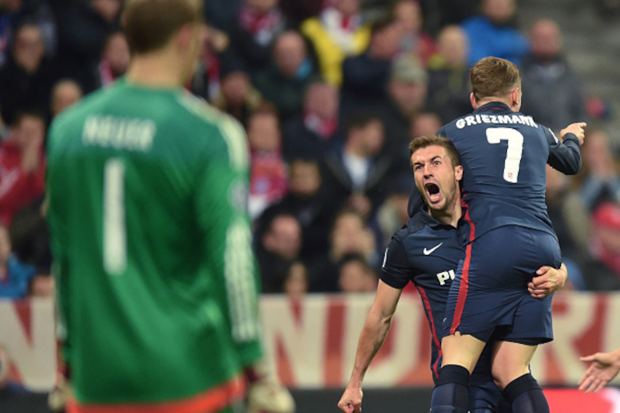 Atletico Madrid's French forward Antoine Griezmann (R) celebrates scoring with Atletico Madrid's midfielder Gabi as Bayern Munich's goalkeeper Manuel Neuer looks on during the UEFA Champions League semi-final, second-leg football match between FC Bayern M Atletico Madrid's French forward Antoine Griezmann (R) celebrates scoring with Atletico Madrid's midfielder Gabi as Bayern Munich's goalkeeper Manuel Neuer looks on during the UEFA Champions League semi-final, second-leg football match between FC Bayern M