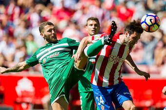 GIJON, SPAIN - SEPTEMBER 11: David Timor of Club Deportivo Leganes duels for the ball with Duje Cop of Real Sporting de Gijon during the La Liga match between Real Sporting de Gijon and Club Deportivo Leganes at Estadio El Molinon on September 11, 2016 in