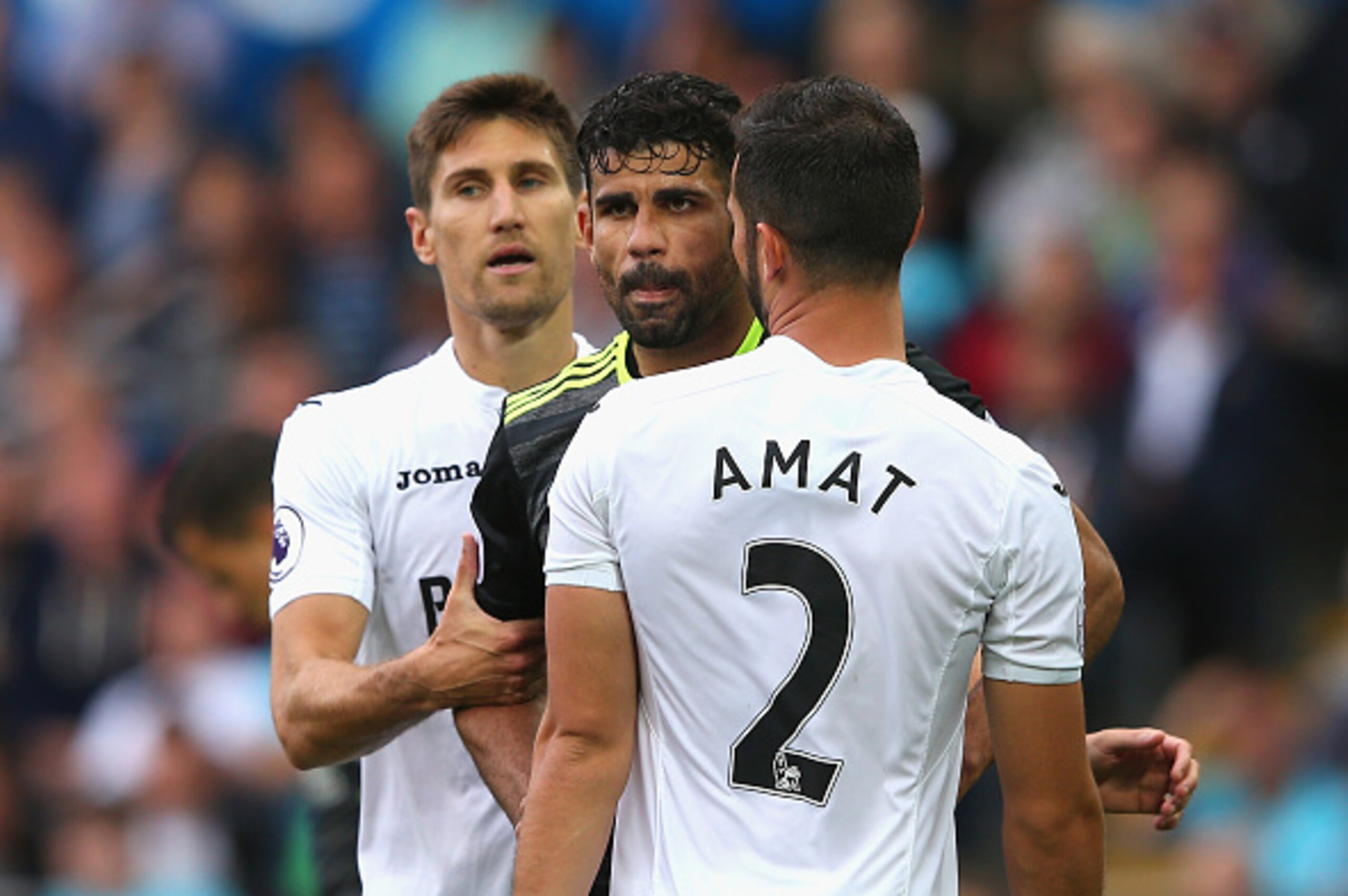 SWANSEA, WALES - SEPTEMBER 11: Diego Costa of Chelsea and Jordi Amat of Swansea City clash as Federico Fernandez of Swansea City intervenes during the Premier League match between Swansea City and Chelsea at Liberty Stadium on September 11, 2016 in Swans SWANSEA, WALES - SEPTEMBER 11: Diego Costa of Chelsea and Jordi Amat of Swansea City clash as Federico Fernandez of Swansea City intervenes during the Premier League match between Swansea City and Chelsea at Liberty Stadium on September 11, 2016 in Swans
