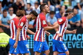 Atletico Madrid's midfielder Koke (2ndR) celebrates after scoring a goal during the Spanish league football match RC Celta de Vigo vs Club Atletico de Madrid at the Balaidos stadium in Vigo on September 10, 2016. / AFP / MIGUEL RIOPA        (Photo credit 