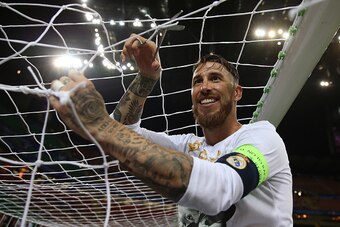 MILAN, ITALY - MAY 28: Sergio Ramos of Real Madrid cuts the goal netting following the UEFA Champions League Final between Real Madrid and Club Atletico de Madrid at Stadio Giuseppe Meazza on May 28, 2016 in Milan, Italy. (Photo by Chris Brunskill Ltd/Get