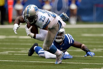 INDIANAPOLIS, IN - SEPTEMBER 11: Detroit Lions' Theo Riddick #25 is tripped up by Indianapolis Colts' Sio Moore #55 during the game between the Detroit Lions and the Indianapolis Colts at Lucas Oil Stadium on September 11, 2016 in Indianapolis, Indiana. (