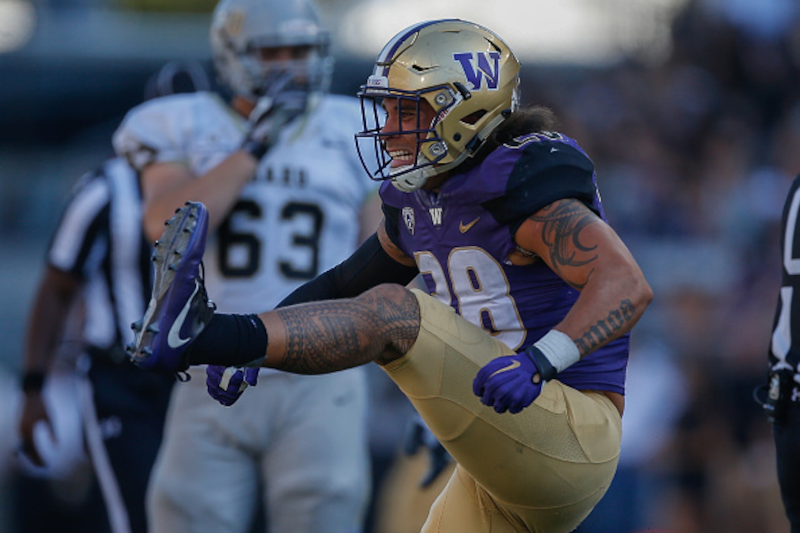 SEATTLE, WA - SEPTEMBER 10:  Linebacker Psalm Wooching #28 of the Washington Huskies reacts after tackling quarterback Matt Linehan of the Idaho Vandals in the second quarter on September 10, 2016 at Husky Stadium in Seattle, Washington.  (Photo by Otto G